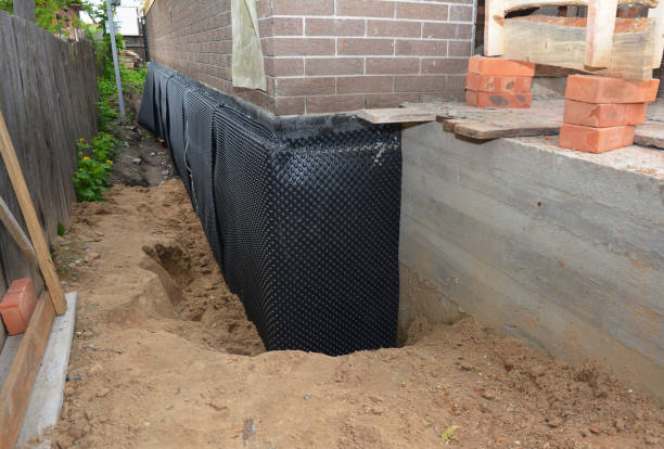 Happy homeowners after waterproofing job in Taft